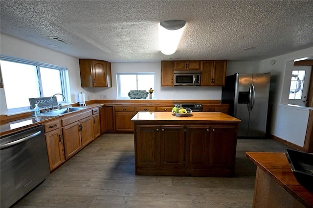12766 Rocky Hill Rd, Prairie Grove, AR 72753 - kitchen featuring a healthy amount of sunlight, a sink, appliances with stainless steel finishes, and a kitchen island
