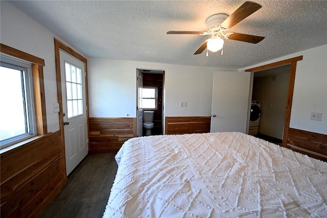 12766 Rocky Hill Rd, Prairie Grove, AR 72753 - unfurnished bedroom with a wainscoted wall, a textured ceiling, wooden walls, washer / clothes dryer, and wood finished floors