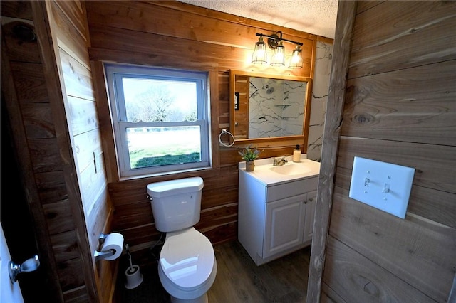 12766 Rocky Hill Rd, Prairie Grove, AR 72753 - half bathroom featuring toilet, vanity, wood walls, and wood finished floors