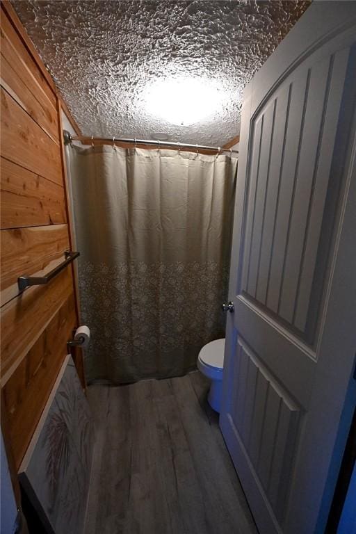 12766 Rocky Hill Rd, Prairie Grove, AR 72753 - full bath with a shower with curtain, wooden walls, wood finished floors, and toilet