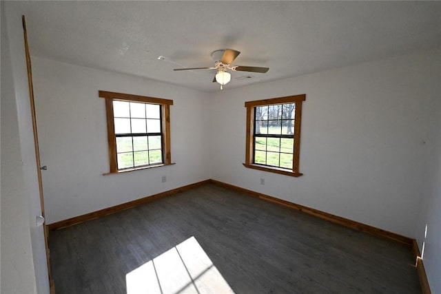 12766 Rocky Hill Rd, Prairie Grove, AR 72753 - unfurnished room with dark wood finished floors, a wealth of natural light, and baseboards