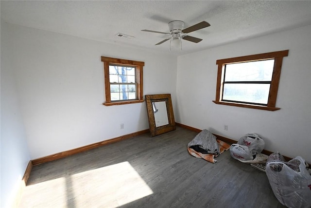 12766 Rocky Hill Rd, Prairie Grove, AR 72753 - unfurnished room with baseboards, a textured ceiling, visible vents, a ceiling fan, and wood finished floors