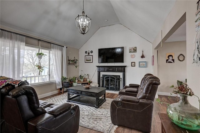 1801 Cash St, Neosho, MO 64850 - living area with baseboards, vaulted ceiling, a chandelier, a high end fireplace, and wood finished floors