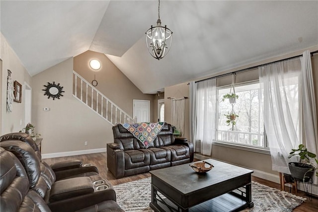 1801 Cash St, Neosho, MO 64850 - living room featuring vaulted ceiling, stairway, a chandelier, wood finished floors, and baseboards