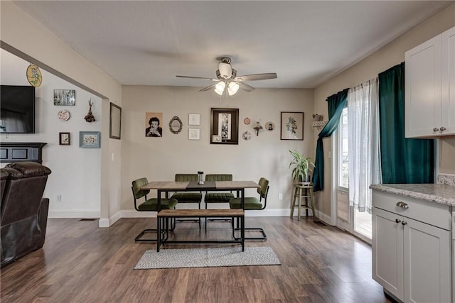 1801 Cash St, Neosho, MO 64850 - dining space featuring baseboards, a ceiling fan, and dark wood finished floors