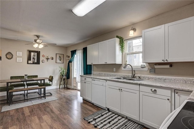 1801 Cash St, Neosho, MO 64850 - kitchen featuring a ceiling fan, dark wood-style flooring, light countertops, a sink, and white dishwasher