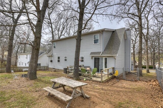 1801 Cash St, Neosho, MO 64850 - rear view of house featuring a wooden deck, central AC, fence private yard, a gate, and a shingled roof