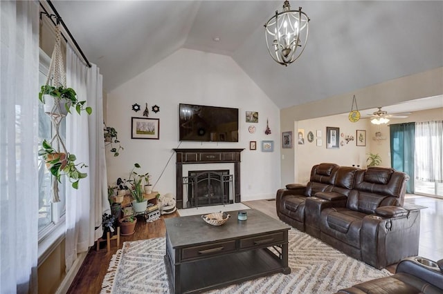 1801 Cash St, Neosho, MO 64850 - living area with a fireplace with flush hearth, ceiling fan with notable chandelier, wood finished floors, and lofted ceiling