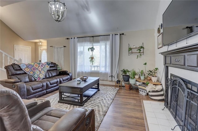 1801 Cash St, Neosho, MO 64850 - living room featuring plenty of natural light, a chandelier, wood finished floors, and a fireplace