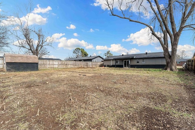 1004 N 30th St, Rogers, AR 72756 - view of yard with fence, a shed, and an outbuilding