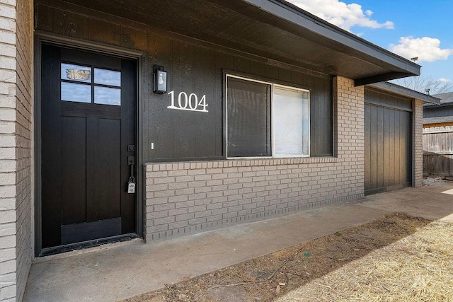 1004 N 30th St, Rogers, AR 72756 - doorway to property featuring brick siding and fence
