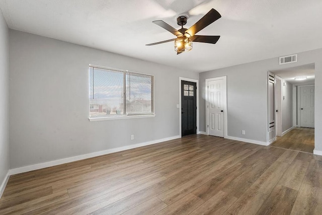 1004 N 30th St, Rogers, AR 72756 - unfurnished room featuring wood finished floors, ceiling fan, and baseboards