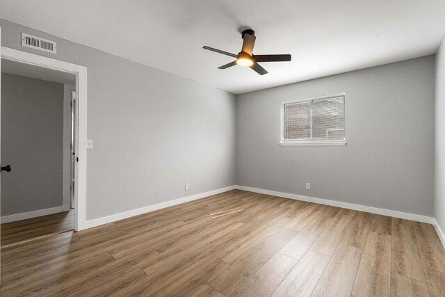 1004 N 30th St, Rogers, AR 72756 - spare room featuring ceiling fan, wood finished floors, and baseboards