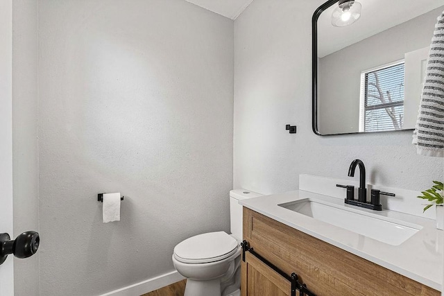 1004 N 30th St, Rogers, AR 72756 - bathroom featuring toilet, vanity, wood finished floors, and baseboards