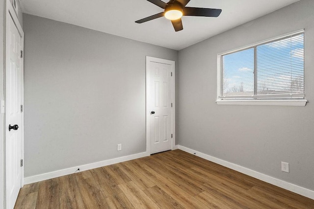 1004 N 30th St, Rogers, AR 72756 - spare room with baseboards, ceiling fan, and wood finished floors