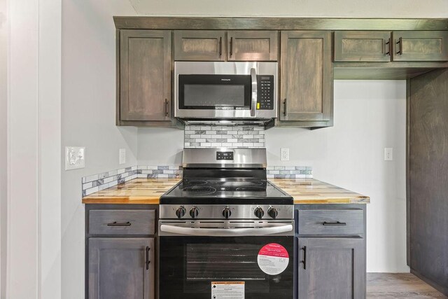 1004 N 30th St, Rogers, AR 72756 - kitchen with stainless steel appliances, wooden counters, tasteful backsplash, and light wood-style floors