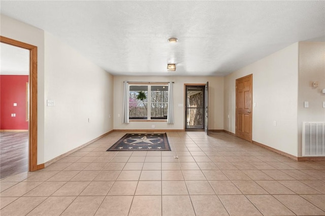 1120 County Road 6012, Berryville, AR 72616 - unfurnished room featuring baseboards, visible vents, a textured ceiling, and light tile patterned floors