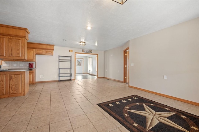 1120 County Road 6012, Berryville, AR 72616 - kitchen with baseboards, tasteful backsplash, a textured ceiling, and light tile patterned floors