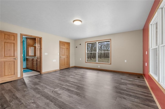 1120 County Road 6012, Berryville, AR 72616 - unfurnished bedroom featuring ensuite bath, baseboards, and wood finished floors