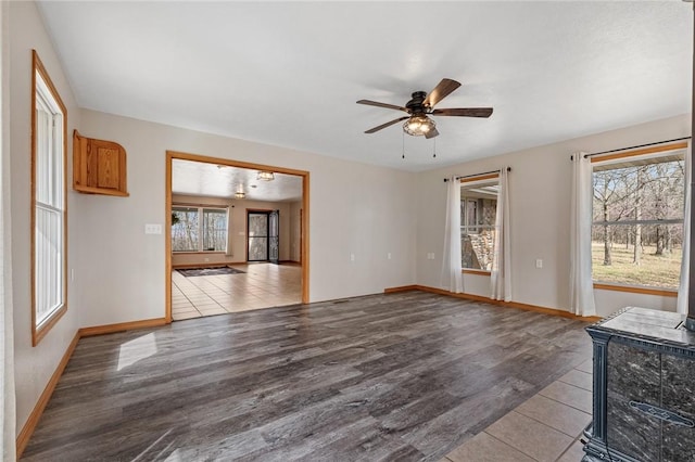 1120 County Road 6012, Berryville, AR 72616 - unfurnished living room featuring wood finished floors, a ceiling fan, and plenty of natural light