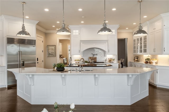 kitchen featuring crown molding, backsplash, a large island, and stainless steel built in fridge