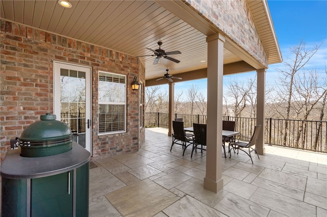 view of patio with outdoor dining area and ceiling fan