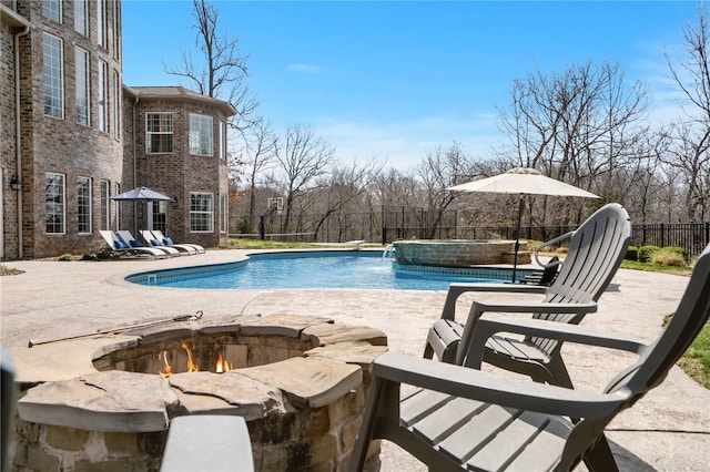 view of pool featuring a fenced in pool, a fire pit, fence, and a patio area