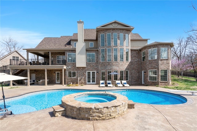 view of pool with an in ground hot tub, french doors, a diving board, a patio area, and a fenced in pool