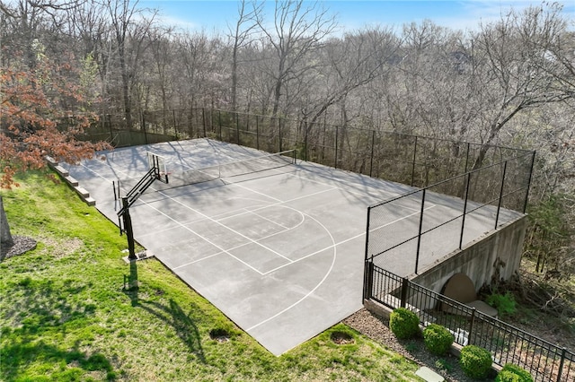 view of basketball court featuring fence, community basketball court, and a yard