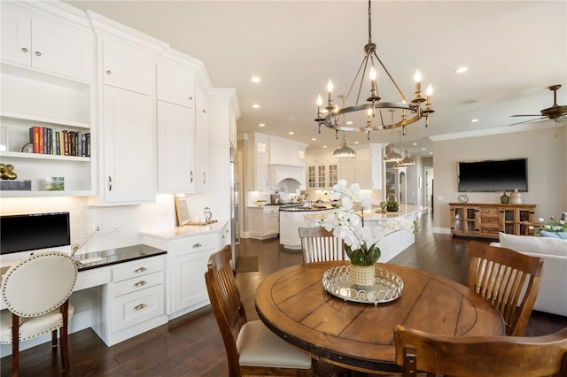 dining space featuring recessed lighting, ornamental molding, dark wood-style flooring, and ceiling fan with notable chandelier