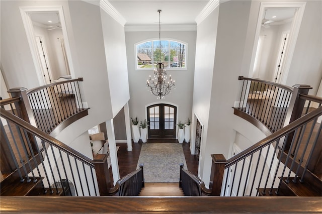 entryway featuring stairway, plenty of natural light, french doors, and wood finished floors