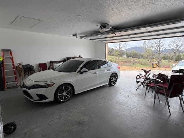 210 Rose Hill Dr, Berryville, AR 72616 - garage with a mountain view and a garage door opener