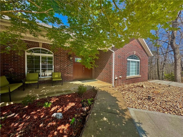 obstructed view of property with brick siding