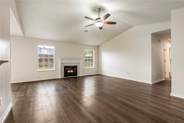 4292 W Beaver Ln, Fayetteville, AR 72704 - unfurnished living room with ceiling fan, a tile fireplace, lofted ceiling, dark wood-type flooring, and a textured ceiling