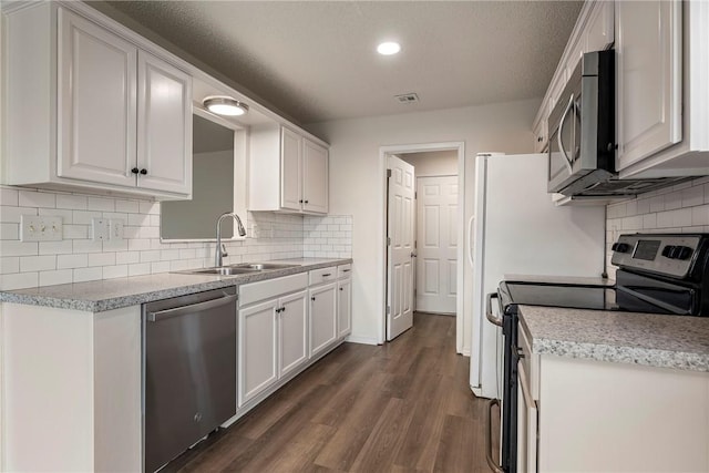 4292 W Beaver Ln, Fayetteville, AR 72704 - kitchen with stainless steel appliances, a sink, white cabinetry, dark wood-style floors, and recessed lighting