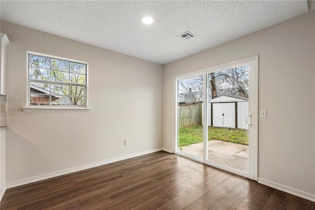4292 W Beaver Ln, Fayetteville, AR 72704 - empty room featuring dark wood-style flooring, healthy amount of natural light, baseboards, a textured ceiling, and recessed lighting
