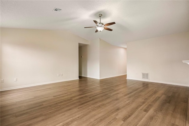 4292 W Beaver Ln, Fayetteville, AR 72704 - empty room with a ceiling fan, lofted ceiling, wood finished floors, baseboards, and a textured ceiling