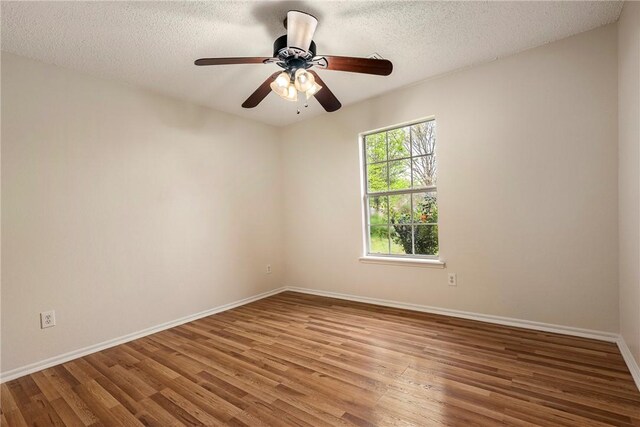 4292 W Beaver Ln, Fayetteville, AR 72704 - spare room featuring wood finished floors, baseboards, a textured ceiling, and ceiling fan