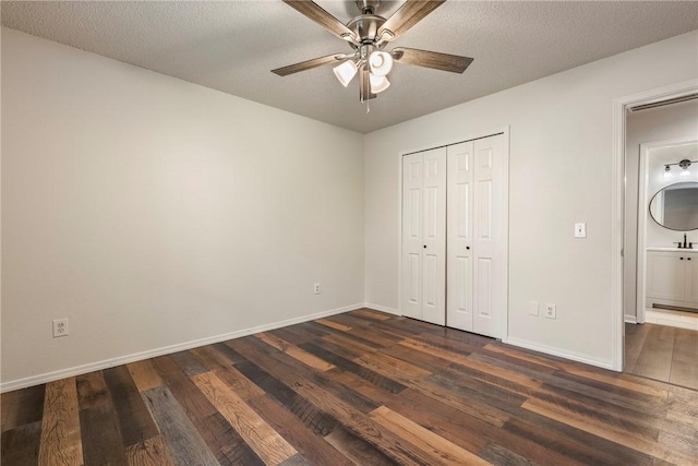 4292 W Beaver Ln, Fayetteville, AR 72704 - unfurnished bedroom with dark wood-type flooring, baseboards, a closet, ceiling fan, and a textured ceiling