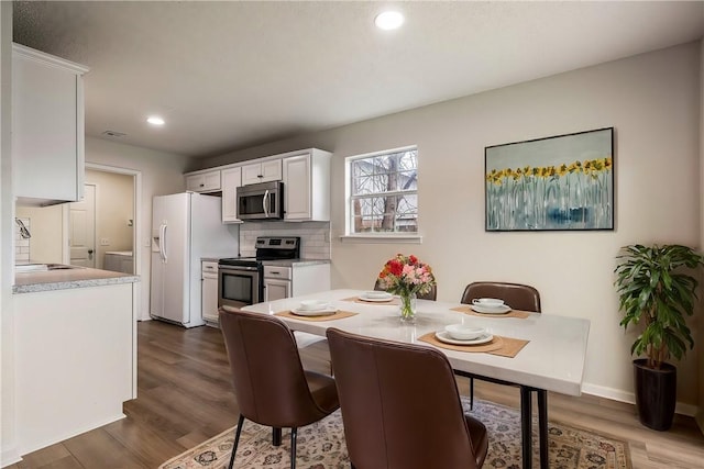 4292 W Beaver Ln, Fayetteville, AR 72704 - dining room featuring dark wood-style floors, recessed lighting, and baseboards