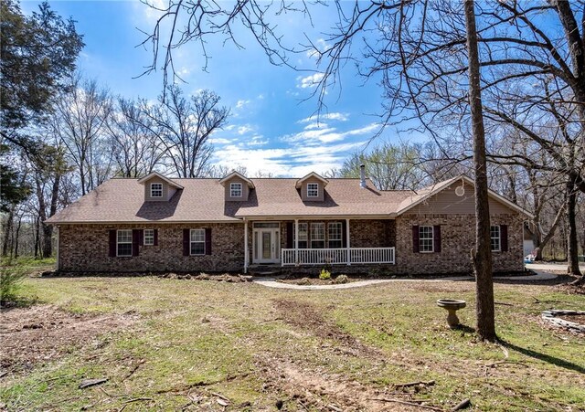 11992 Cripps Rd, Gentry, AR 72734 - view of front of house with a front yard, covered porch, and brick siding