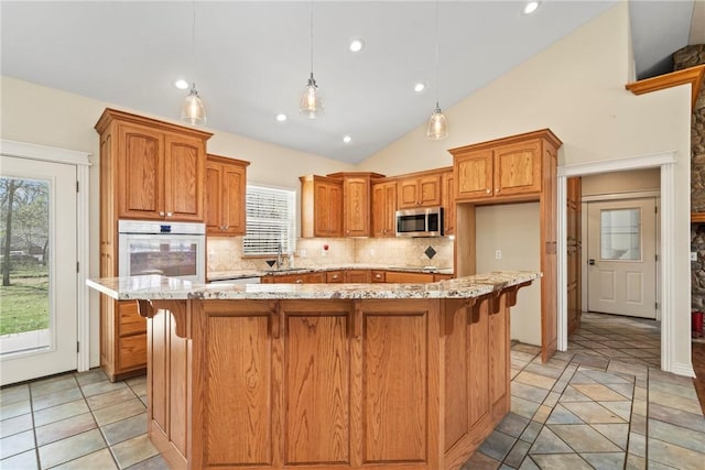 11992 Cripps Rd, Gentry, AR 72734 - kitchen featuring stainless steel microwave, light stone countertops, a sink, and oven