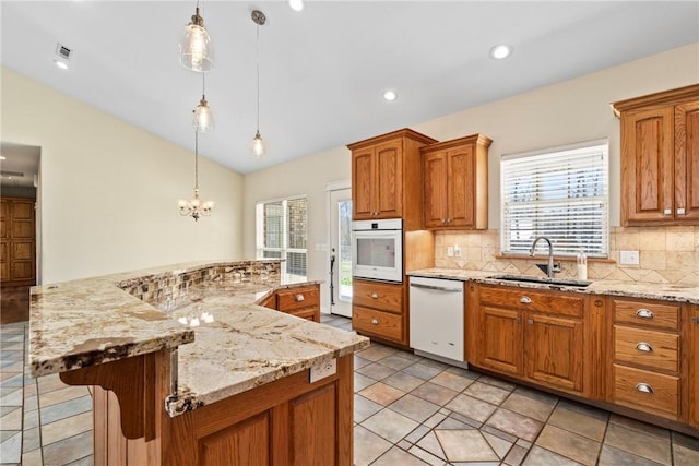 11992 Cripps Rd, Gentry, AR 72734 - kitchen featuring a sink, vaulted ceiling, brown cabinets, and white appliances