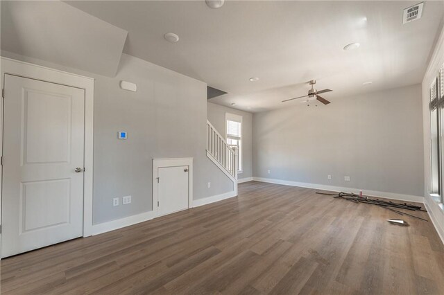 852 S Waxflower Ave, Fayetteville, AR 72701 - unfurnished living room with stairs, baseboards, visible vents, a ceiling fan, and wood finished floors