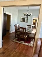 805 N Front St, Dardanelle, AR 72834 - dining area with dark wood-style flooring and an inviting chandelier