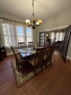 805 N Front St, Dardanelle, AR 72834 - dining space featuring an inviting chandelier and dark wood-style floors
