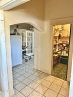 805 N Front St, Dardanelle, AR 72834 - corridor featuring arched walkways and light tile patterned flooring