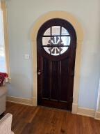 805 N Front St, Dardanelle, AR 72834 - entryway with arched walkways, baseboards, and wood finished floors