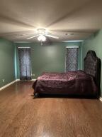 604 S Seattle Ave, Russellville, AR 72801 - bedroom with wood finished floors and baseboards