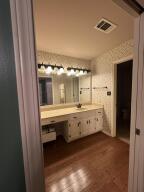 604 S Seattle Ave, Russellville, AR 72801 - bathroom featuring visible vents, wood finished floors, and vanity